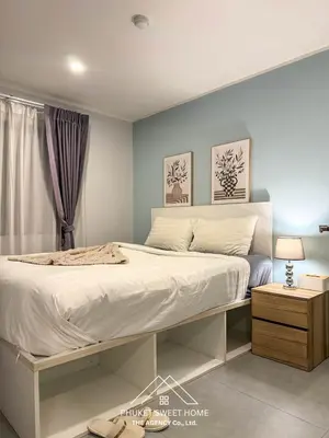 a bedroom with a large bed with white sheets at Condo for rent chalong Rawai 610 in Ban Klang