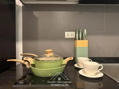 a green pot sitting on top of a stove with cups at Condo for rent chalong Rawai 610 in Ban Klang
