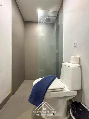 a bathroom with a toilet with a blue towel on it at Condo for rent chalong Rawai 610 in Ban Klang