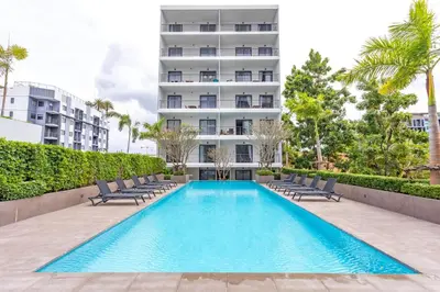 a swimming pool with chairs and a building at Condo for rent chalong Rawai 610 in Ban Klang