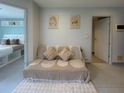 a living room with a couch with pillows on it at Condo for rent chalong rawai 106 in Ban Klang
