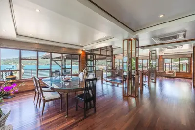 a dining room with a table and chairs at 35 - Vast Beach Front Villa in Kamala Beach