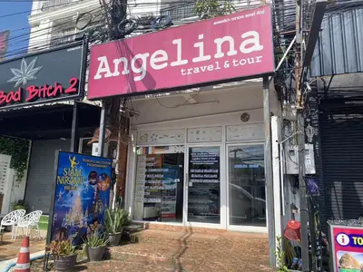 a store with a sign on the side of a building at Angelina Guesthouse in Patong Beach