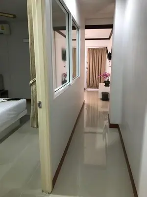 a hallway with a door leading to a bedroom at Angelina Guesthouse in Patong Beach