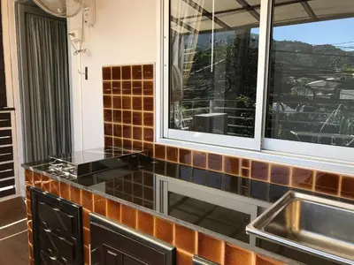 a kitchen with a sink and a window at Angelina Guesthouse in Patong Beach
