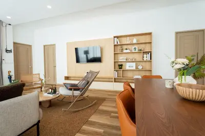 a living room with a table and a tv at Villa Asteria Krabi - Luxury 3 Bedroom Pool Retreat in Ao Nang in Ban Khlong Haeng