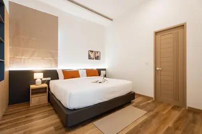 a bedroom with a large white bed and a door at Villa Asteria Krabi - Luxury 3 Bedroom Pool Retreat in Ao Nang in Ban Khlong Haeng