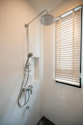 a shower in a white bathroom with a window at Villa Asteria Krabi - Luxury 3 Bedroom Pool Retreat in Ao Nang in Ban Khlong Haeng