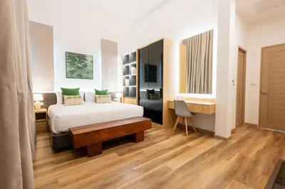 a bedroom with a bed and a desk and a chair at Villa Asteria Krabi - Luxury 3 Bedroom Pool Retreat in Ao Nang in Ban Khlong Haeng