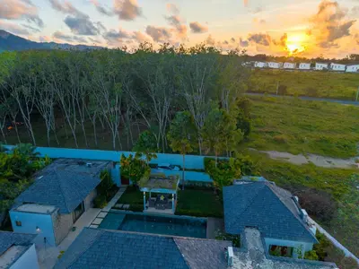 an aerial view of a house with a swimming pool at BangTao Luxury 5 Bedroom 1200sqm Modern Bali Style Holiday Villa Quiet and Private Large Private Pool Large Garden in Bang Tao Beach