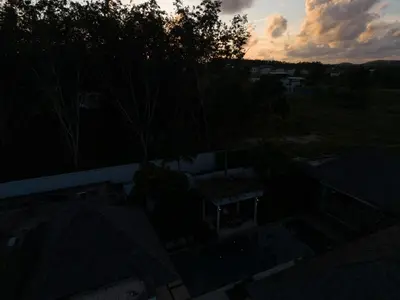 an overhead view of the roofs of houses at sunset at BangTao Luxury 5 Bedroom 1200sqm Modern Bali Style Holiday Villa Quiet and Private Large Private Pool Large Garden in Bang Tao Beach