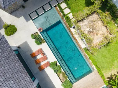 an overhead view of a large swimming pool at BangTao Luxury 5 Bedroom 1200sqm Modern Bali Style Holiday Villa Quiet and Private Large Private Pool Large Garden in Bang Tao Beach