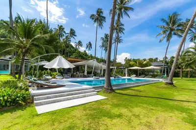 an image of a resort swimming pool with palm trees at Baan Klong III in Ko Yao Noi