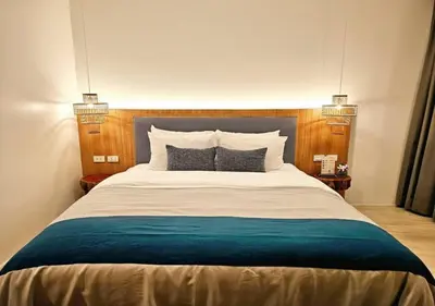 a bedroom with a large bed with two pillows at La La Lay Beach House in Klong Muang Beach