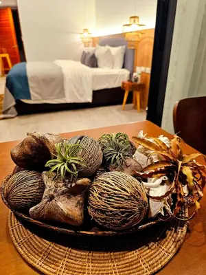 a bowl of plants on a table in a bedroom at La La Lay Beach House in Klong Muang Beach
