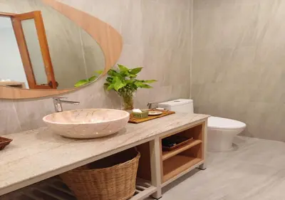 a bathroom with a sink and a mirror and a toilet at La La Lay Beach House in Klong Muang Beach