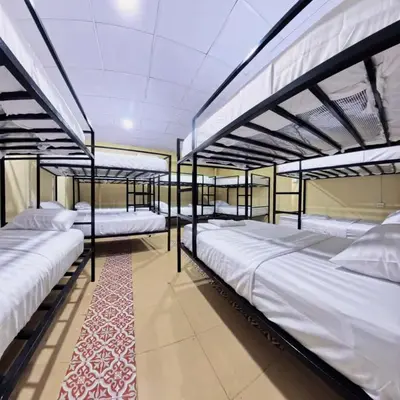 three bunk beds in a room with a carpet at Vista Inn Patong in Patong Beach