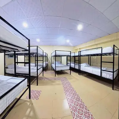a room with four bunk beds and a carpet at Vista Inn Patong in Patong Beach