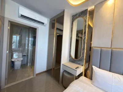 a bathroom with a bed and a sink and a mirror at Новая студия Bellevue Bangtao in Laguna Phuket