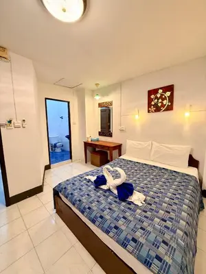 a bedroom with a bed with towels on it at Om Sab House Patong in Patong Beach