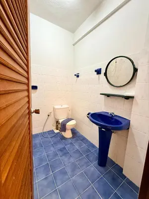 a bathroom with a blue sink and a toilet at Om Sab House Patong in Patong Beach