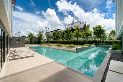 a swimming pool in front of a building at Ozone Condominium BangTao Laguna Area in Phuket
