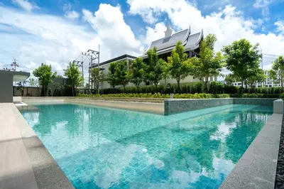a large swimming pool in front of a building at Ozone Condominium BangTao Laguna Area in Phuket