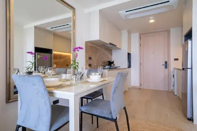 a kitchen and dining room with a table and chairs at Ozone Condominium BangTao Laguna Area in Phuket