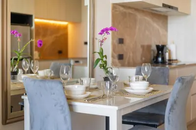a dining room table with wine glasses on it at Ozone Condominium BangTao Laguna Area in Phuket