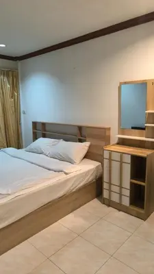 a bedroom with a bed and a flat screen tv at Didim Guest House Patong in Patong Beach