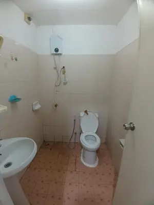 a bathroom with a toilet and a sink at Didim Guest House Patong in Patong Beach