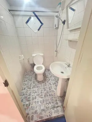 a bathroom with a toilet and a sink at Didim Guest House Patong in Patong Beach