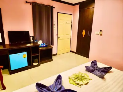 a room with a bed and a tv in a room at Hotel Hollywood Inn Love Patong in Patong Beach