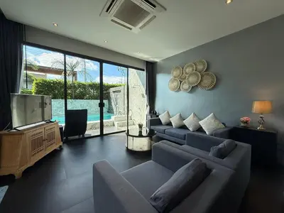 a living room with two couches and a television at 2 Bedroom Pool Villa Chalong in Chalong