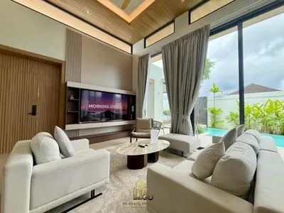 a living room with white furniture and a tv at 4 Br Pool Villa in Chalong in Phuket Town