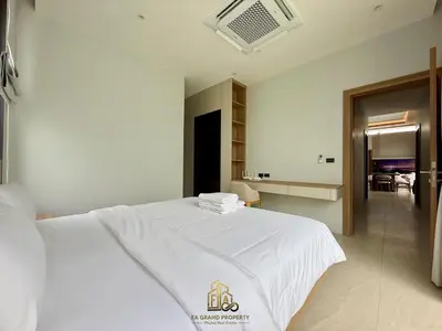 a bedroom with a white bed and a dining room at 4 Br Pool Villa in Chalong in Phuket Town