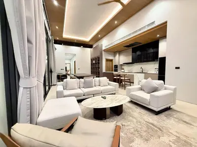 a living room with white furniture and a kitchen at 4 Br Pool Villa in Chalong in Phuket Town