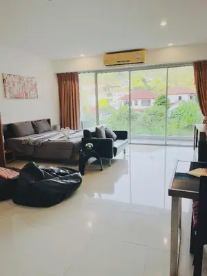 a living room with a bed and a couch at CHIC Beautiful apartment by the seaside, terrace, pool, free gym in Karon Beach