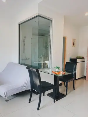 a bedroom with a bed and a glass table and chairs at CHIC Beautiful apartment by the seaside, terrace, pool, free gym in Karon Beach