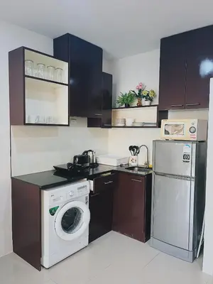a kitchen with a washing machine and a dishwasher at CHIC Beautiful apartment by the seaside, terrace, pool, free gym in Karon Beach