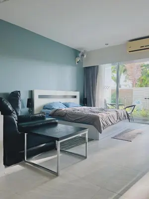 a bedroom with a bed and a coffee table at CHIC Beautiful apartment by the seaside, terrace, pool, free gym in Karon Beach