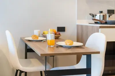 a wooden table with two glasses of orange juice at Cosy 1 bedroom apt at Space Cherngtalay - 402 in Bang Tao Beach