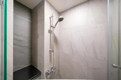 a shower with a glass door in a bathroom at Cosy 1 bedroom apt at Space Cherngtalay - 402 in Bang Tao Beach