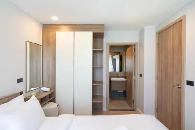 a bedroom with a white bed and a closet at Brand new 1 BR apt 403 at Space Condo near Boat Avenue in Bang Tao Beach