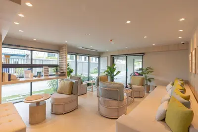 a living room with a lot of furniture and windows at Brand new 1 BR apt 403 at Space Condo near Boat Avenue in Bang Tao Beach