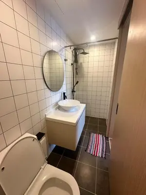 a bathroom with a toilet and a sink and a mirror at FantaSea Kamala By Ere in Kamala Beach