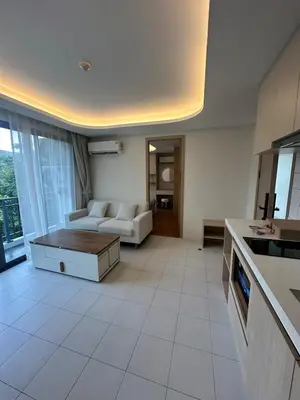 a living room with a couch and a table at FantaSea Kamala By Ere in Kamala Beach