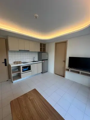 a large kitchen with white tiled floors and appliances at FantaSea Kamala By Ere in Kamala Beach
