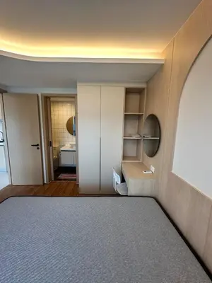 a room with a bed and a bathroom at FantaSea Kamala By Ere in Kamala Beach
