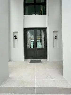 a black door on a white building with a tile floor at Fifth Element Pool Villa By Ere in Laguna Phuket